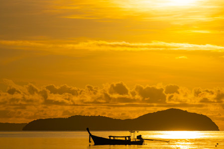 Amazing sunset or sunrise sky over sea landscape,Beautiful colorful light of nature with boats in the sea,Majestic nature view seascapeの写真素材