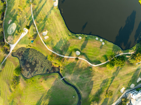 Aerial view drone shot of beautiful green golf field at sunset or sunset time,Wide angle Top viewの写真素材