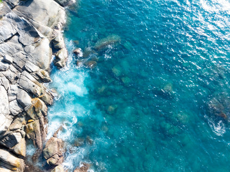 Amazing tropical seashore landscape background,Top view waves crashing on rocksの写真素材