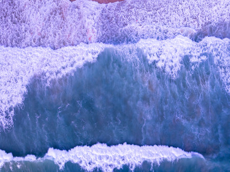 Amazing Top view sea beach landscape background,Summer sea waves crashing on sandy shore seascape background,High angle view ocean nature backgroundの写真素材