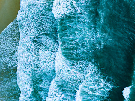 Overhead view to blue stormy ocean waves with white foam in the ocean,Sea water with splashes and...