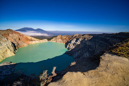 Aerial view Kawah Ijen volcano with turquoise sulfur water lake at sunrise.Amazing nature landscape...
