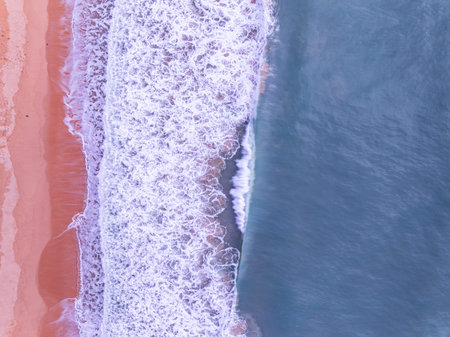 Aerial top view nature background of waves crashing in the ocean sea water, Drone view of sea waves...