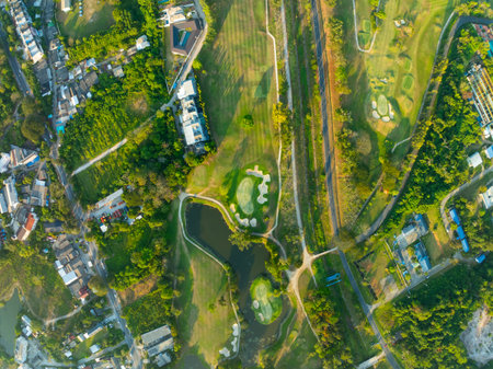 Aerial view drone shot of beautiful green golf field at Phuket island Thailand,Wide angle Top view golf courseの写真素材
