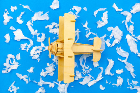 Wood Airplane with paper ball Instead of white clouds on blue paper background ,Preparation for Traveling and tour concept.の写真素材