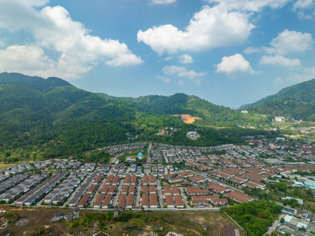Aerial view of residential houses and driveways neighborhood during a fall sunset or sunrise time.Tightly packed homes.Top view over building houses in phuket thailandの写真素材