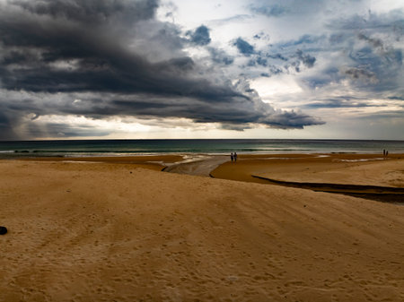Landscape of dark rain clouds over ocean,stormy dark clouds over sand beach in Phuket island...