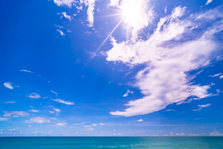 Blue sky white clouds over sea nature backgroundの写真素材