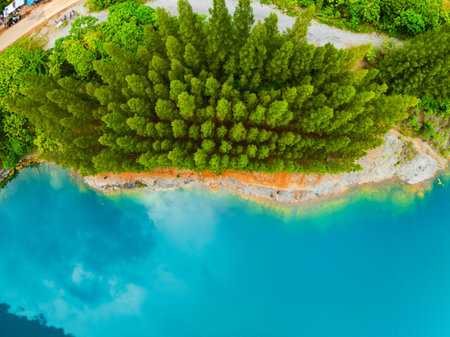 Aerial view of amazing pond in tropical rainforest with mountain rocks peak, Beautiful water surface...