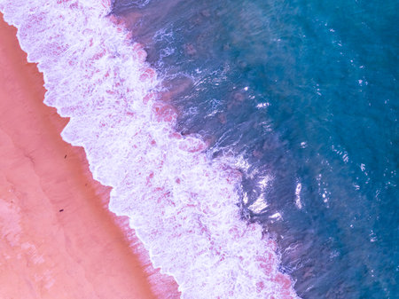 Pink beach with blue ocean waves crashing on sandy shore,Aerial view of holidays beach copy space,Beautiful sand surface Concept holiday summer background Travel destinationの写真素材