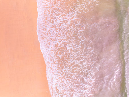 Amazing Top view colorful pink sand beach landscape background,Summer sea waves crashing on sandy shore seascape background,High angle view ocean nature beach backgroundの写真素材