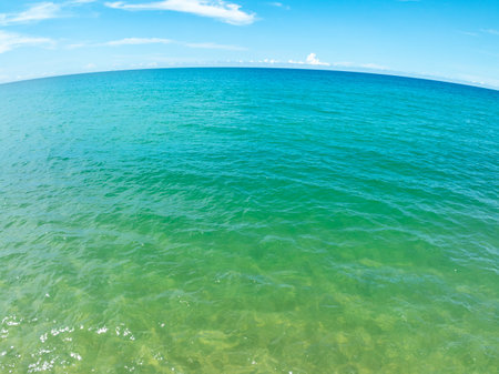 Aerial view of blue sea surface water texture background,Sun reflections on water, Aerial flying drone view Waves water surface texture on sunny tropical oceanの写真素材