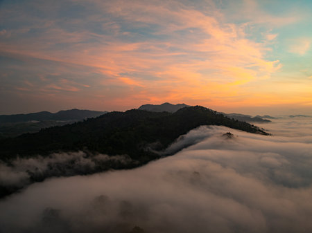 Aerial view Beautiful natural landscape Rainforest mountains in the sunrise or sunset time,Natural scenery tropical forest and fog in asia,Wide angle view drone shotの写真素材