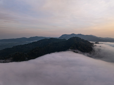 Aerial view Beautiful natural landscape Rainforest mountains in the sunrise or sunset time,Natural scenery tropical forest and fog in asia,Wide angle view drone shotの写真素材