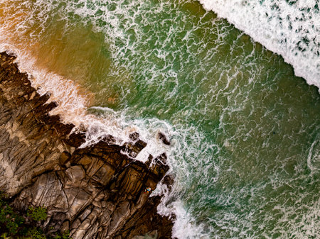 Top view seashore waves nature background,Amazing waves crashing on rocks seascape viewの写真素材