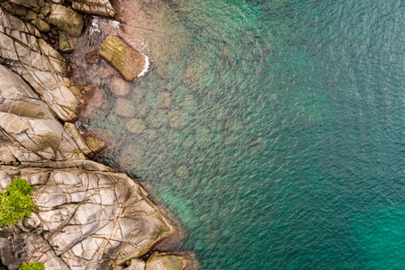Top view waves crashing on rocks seascape background,Wide angle sea nature backgroundの写真素材