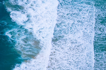 Amazing Top view sea beach landscape background,Summer sea waves crashing on sandy shore seascape background,High angle view ocean nature backgroundの写真素材
