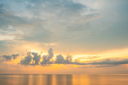 Nature beautiful light sunset or sunrise over sea surface,Colorful sunset sky with clouds and waves in the ocean,Wide angle sea backgroundの写真素材