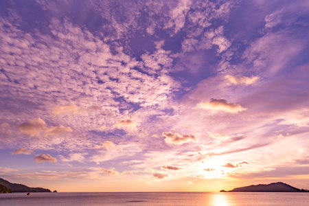 Nature beautiful light sunset or sunrise over sea surface,Colorful sunset sky with clouds and waves in the ocean,Wide angle sea backgroundの写真素材