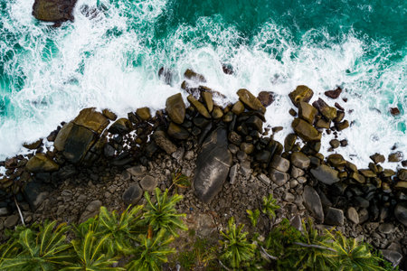 Aerial view Top down seashore, Waves crashing on rocks cliff, Beautiful sea surface in sunny day summer background, Amazing seascape top view seacoastの写真素材