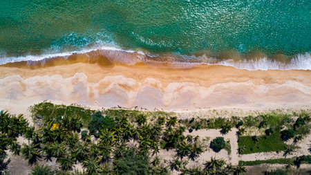 Aerial view Top down seashore, Waves crashing on rocks cliff, Beautiful sea surface in sunny day summer background, Amazing seascape top view seacoast at Phuket Thailandの写真素材