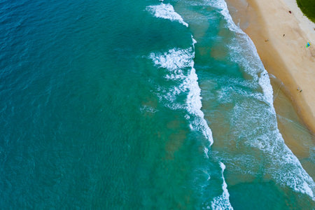 Aerial view Waves crashing on sandy shore,Sea surface in summer day background,Seascape top view waves texture background.の写真素材