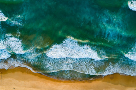 Aerial view Waves crashing on sandy shore,Sea surface in summer day background,Seascape top view...