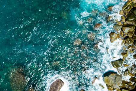 Aerial view Waves crashing on sandy shore,Sea surface in summer day background,Seascape top view waves texture background.の写真素材
