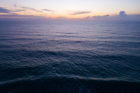 Aerial view sunset sky,Nature beautiful light sunset or sunrise over sea,Colorful dramatic majestic scenery sunset Sky with Amazing clouds and waves texture colorful sky cloud background.の写真素材