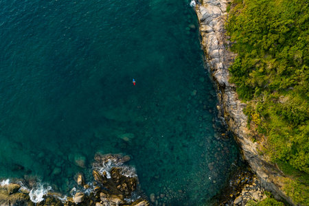 Aerial view Top down seashore, Waves crashing on rocks cliff, Beautiful sea surface in sunny day...