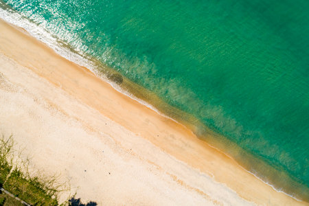 Aerial view Waves crashing on sandy shore,Sea surface in summer day background,Seascape top view waves texture background.の写真素材