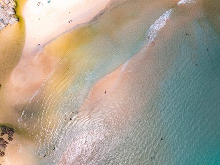Top view beach with waves crashing on sandy shore,Beautiful waves sea surface in summer seascape...