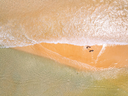 Top view beach with waves crashing on sandy shore,Beautiful waves sea surface in summer seascape...
