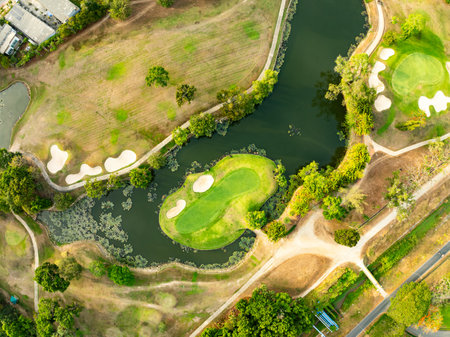 Aerial view drone shot of beautiful green golf field fairway and putting green,Top down image for sport background and travel nature backgroundの写真素材