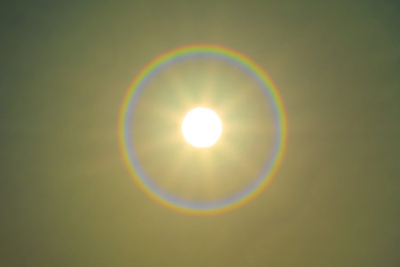 Shining sun on sunset sky with lens flare of sunlight on sky background Bright sun on golden sky...