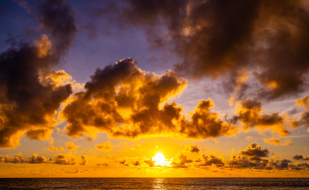 Beautiful sunset or sunrise over the sea with colorful clouds,Amazing clouds and majestic light nature backgroundの写真素材