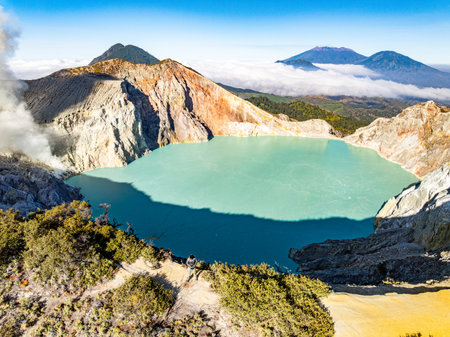 Aerial view of rock cliff at Kawah Ijen volcano with turquoise sulfur water lake at sunrise.Amazing nature landscape view at East Java, Indonesia.Natural landscape colorful sky backgroundの写真素材