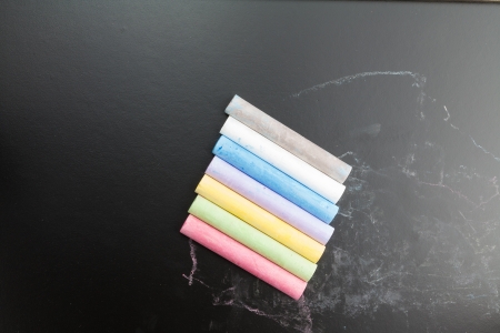 Row of color chalk on a blackboardの写真素材