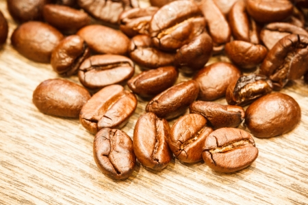Fresh coffee beans on woodの写真素材