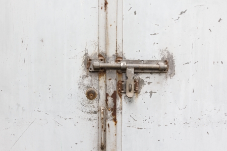 Metal door with lock in grungy styleの写真素材