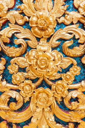Golden wooden statue of the Thai style wallの写真素材