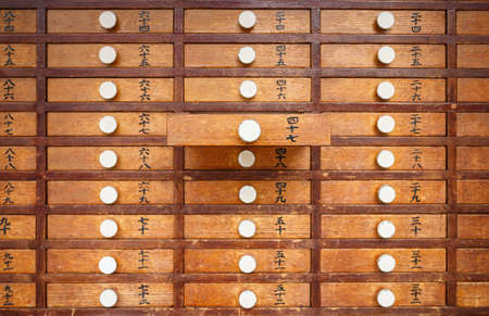 wooden cabinet for fortunetelling with paperの写真素材