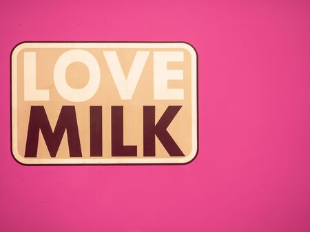 The aluminum plate in retro style pink background with copy space for decorating with love milk text.の写真素材