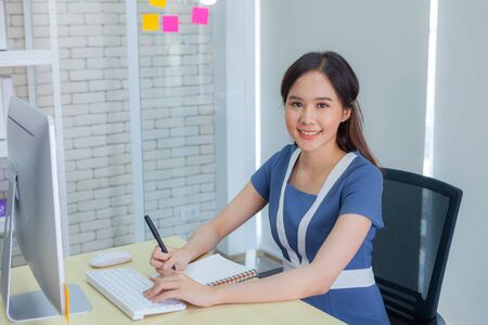 Asian businesswoman smiles brightly while doing important transactions with business negotiators in the Modern office during working hours.の写真素材