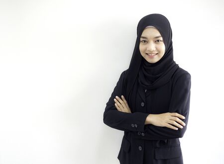 Smart beautiful Asian Muslim woman in modern kurung and hijab.  Positive human emotion facial expression body language.の写真素材