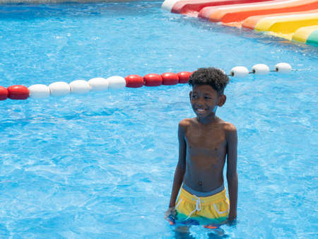 Portrait of a cute African American boy smiled happily after slipping down a steep slider.の写真素材