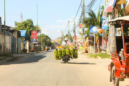 Motorcycle transport bananas with wifeのeditorial素材