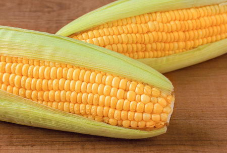 fresh corn on wooden table