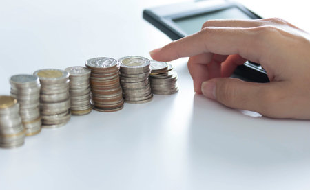 Closeup of hand put Coins to stack of coins,Concept Saving money.