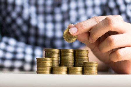 Saving money concept preset by Male hand putting money coin stack growing business